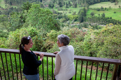 Senior mother and adult daughter traveling at the  view point over the cocora valley at salento