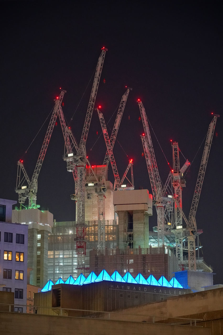 ILLUMINATED FERRIS WHEEL AGAINST SKY