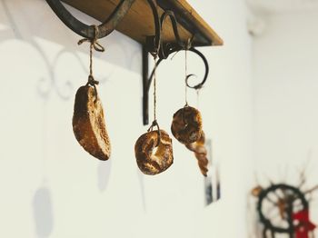 Low angle view of decoration hanging on wall at bakery