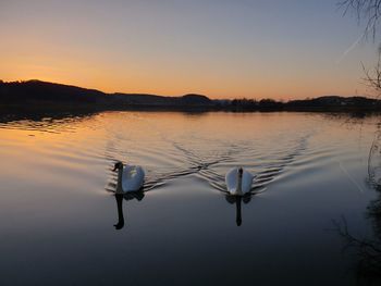 Scenic view of lake against sky during sunset