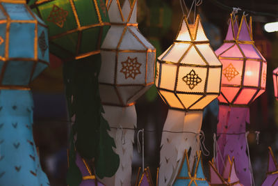 Close-up of illuminated lanterns hanging in market