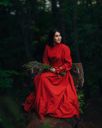 Portrait of a smiling young woman in forest