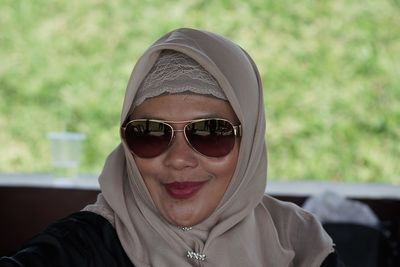 Close-up of smiling woman wearing sunglasses and hijab