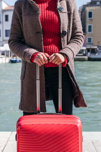 Close up of a woman holding luggage travel bag