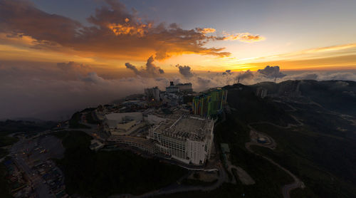 High angle view of buildings in city during sunset