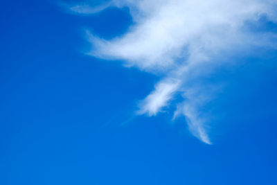 Low angle view of vapor trail in blue sky