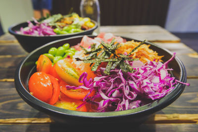 High angle view of salad in bowl on wooden table