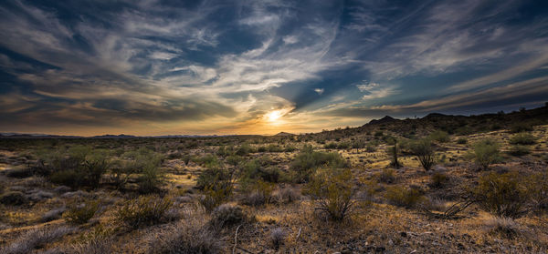 Scenic view of landscape against sky during sunset