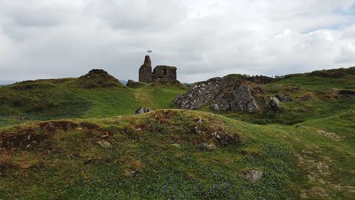 Built structure on rocks against sky