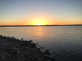 Scenic view of sea against clear sky during sunset