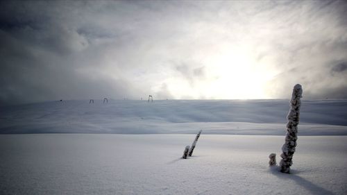 Scenic view of frozen landscape against sky