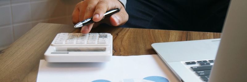 High angle view of man using mobile phone on table