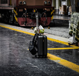 Suitcase against train at railroad station