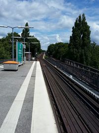 Railroad track against cloudy sky