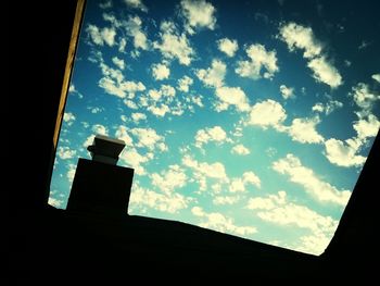 Low angle view of building against cloudy sky