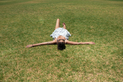 High angle view of woman lying on grass