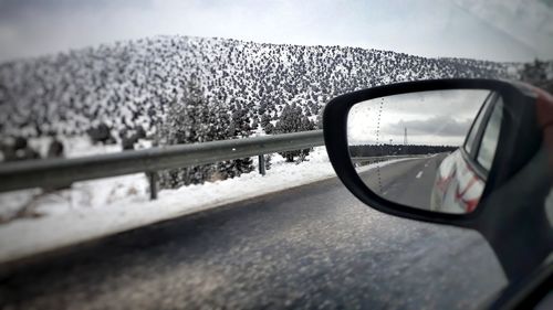 Reflection of car on side-view mirror