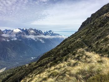 Scenic view of mountains against cloudy sky