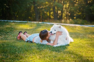 Young woman with dog on field