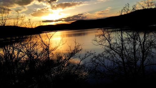 Scenic view of lake against sky during sunset