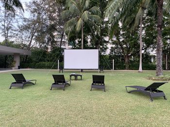 Empty chairs and table in park