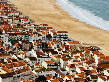 High angle view of townscape by sea