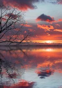 Scenic view of lake against romantic sky at sunset