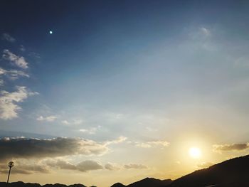 Low angle view of silhouette mountains against sky during sunset