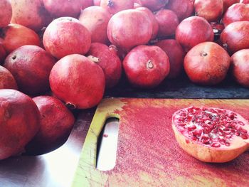 Close-up of halved pomegranate on cutting board