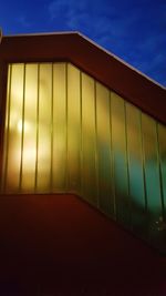 Low angle view of wall against blue sky