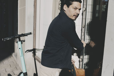 Businessman looking away while entering in office