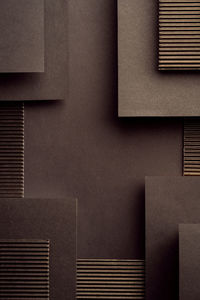 Geometric black background made of corrugated cardboard and paper