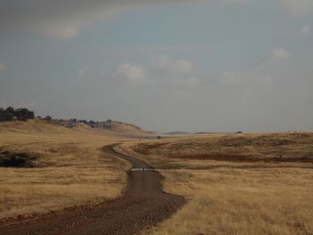 Road amidst landscape against sky