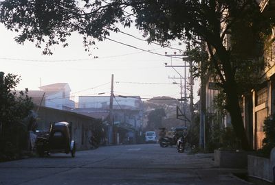 Cars on road along buildings