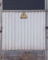 Close-up of umbrella on wood against wall