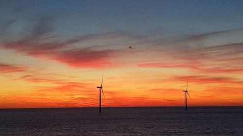 Scenic view of sea against orange sky