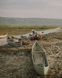 Boats moored on lake against sky