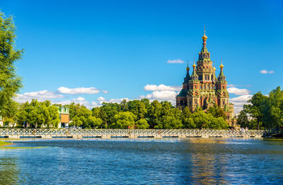 View of building by river against sky