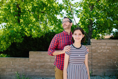 Portrait of a smiling young couple standing outdoors