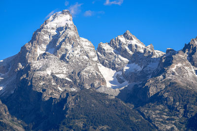 Scenic view of snowcapped mountains against blue sky