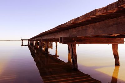 Pier over sea against clear sky