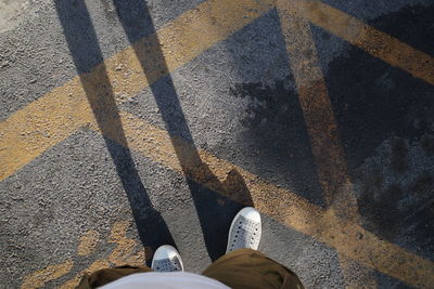 Low section of person standing on street