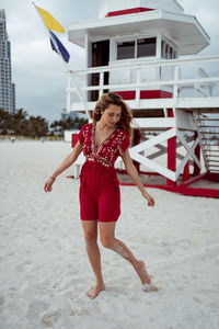 Full length of woman with red umbrella