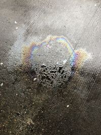 High angle view of rainbow over wet road