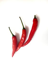 Close-up of red chili over white background