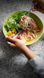 Midsection of person holding food in bowl