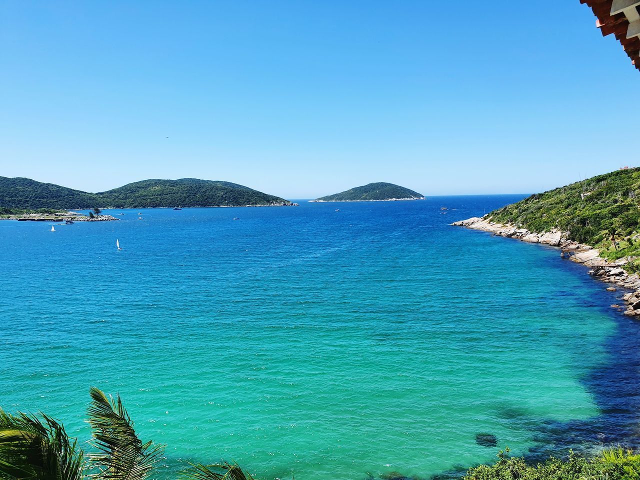 SCENIC VIEW OF BAY AGAINST CLEAR SKY