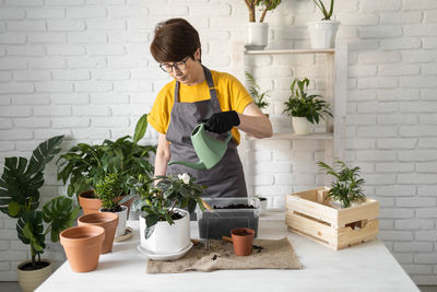 Side view of woman gardening at home