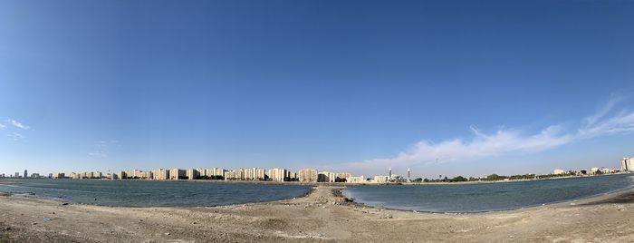 Panoramic view of beach against blue sky