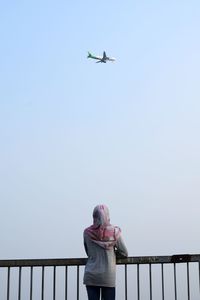 Low angle view of airplane flying against clear sky